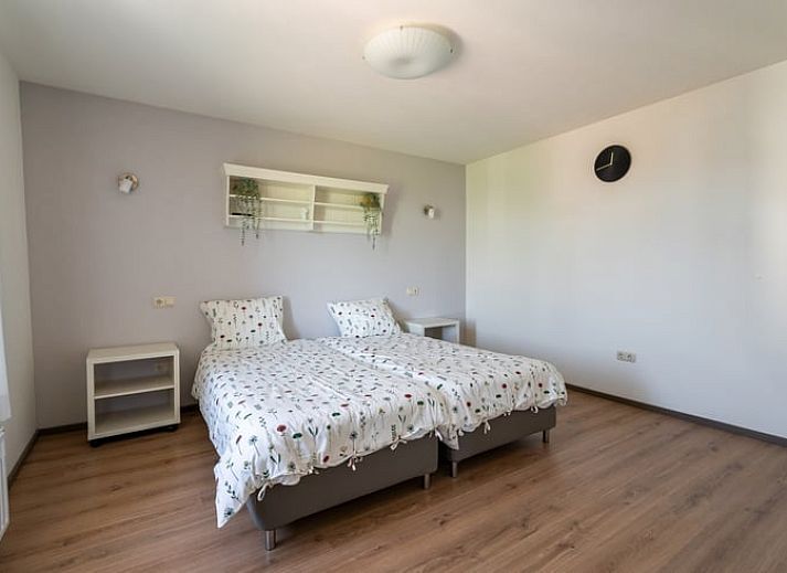 Stylish living room of Holiday home in Klimmen, South Limburg, with wooden floor and modern interior.
