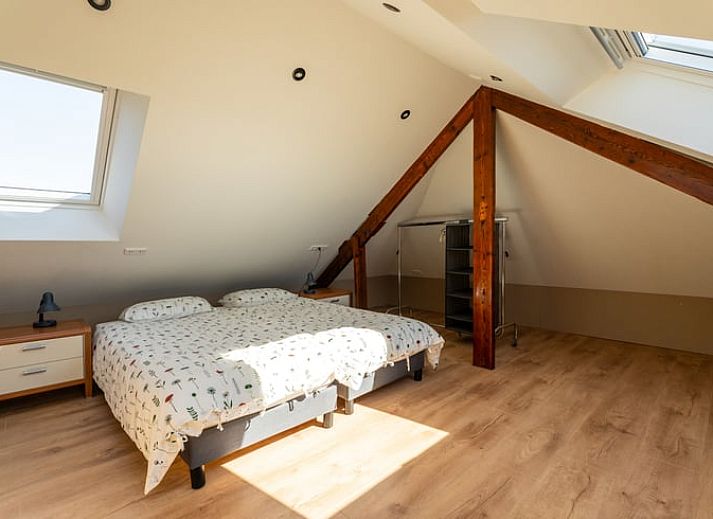 Cozy sitting area in Holiday Home in Klimmen, South Limburg, with comfortable sofa and dining area.