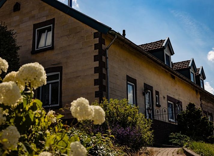 Dining room with fireplace in Holiday home in Wijlre, ideal for cozy evenings in South Limburg.