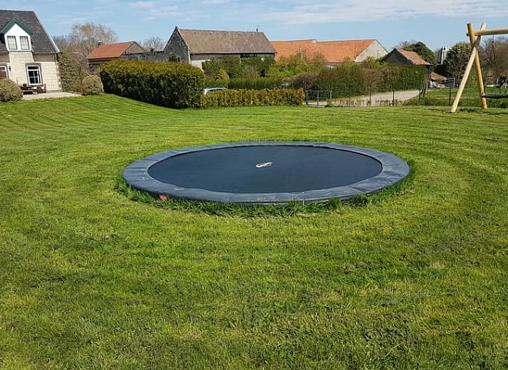 Dining room with fireplace in Holiday home in Wijlre, ideal for cozy evenings in South Limburg.