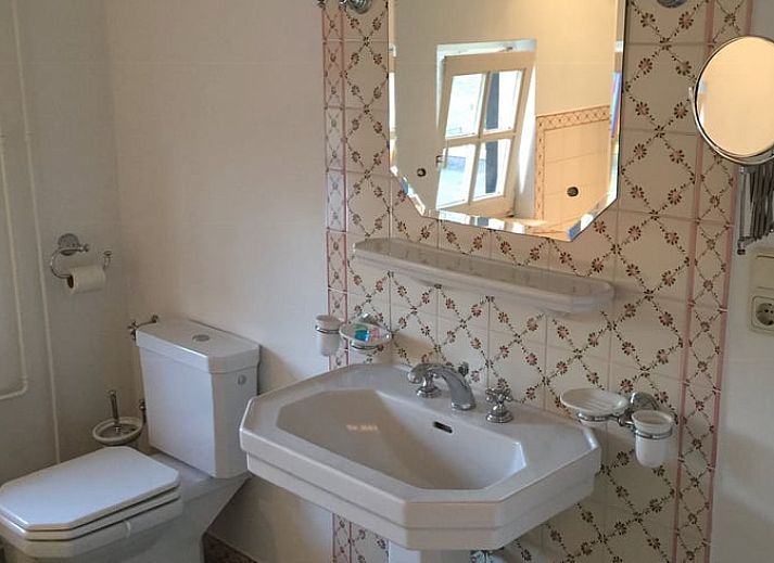 Spacious dining room in Holiday Home in Epen, Limburg, with wooden beams and mood lighting.
