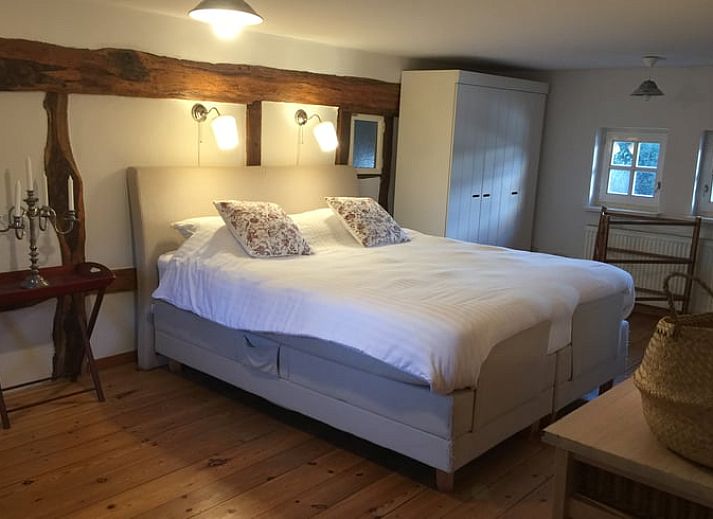Spacious dining room in Holiday Home in Epen, Limburg, with wooden beams and mood lighting.