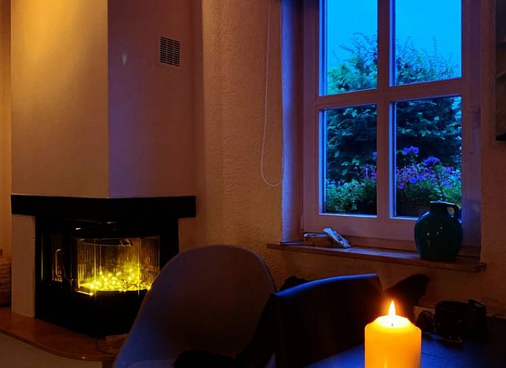Modern kitchen in Cottage in Epen, South Limburg, vacation home with sleek white cabinets and garden views.