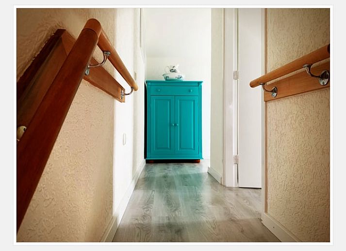Modern kitchen in Cottage in Epen, South Limburg, vacation home with sleek white cabinets and garden views.