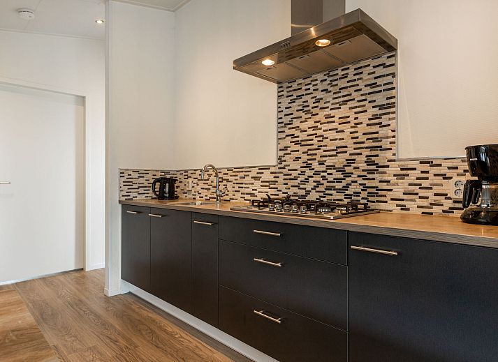 Cozy living room in Holiday Home Green Resort Mooi Bemelen overlooking nature in Limburg.