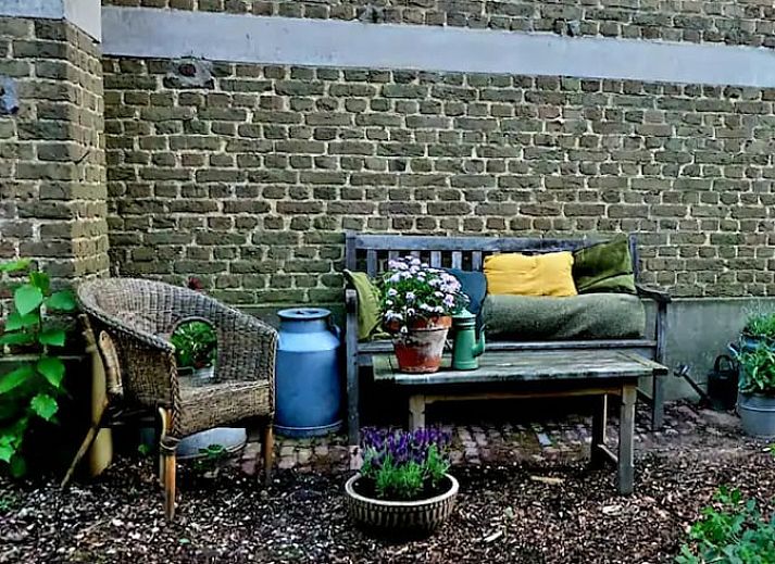 Eetgedeelte in Vakantiehuis in Heerlen, Zuid Limburg met rustieke tafel en groene planten.