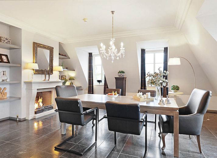 Luxury interior of Kasteeldomein De Cauberg penthouse in Valkenburg, South Limburg, with elegant living room and cozy fireplace.