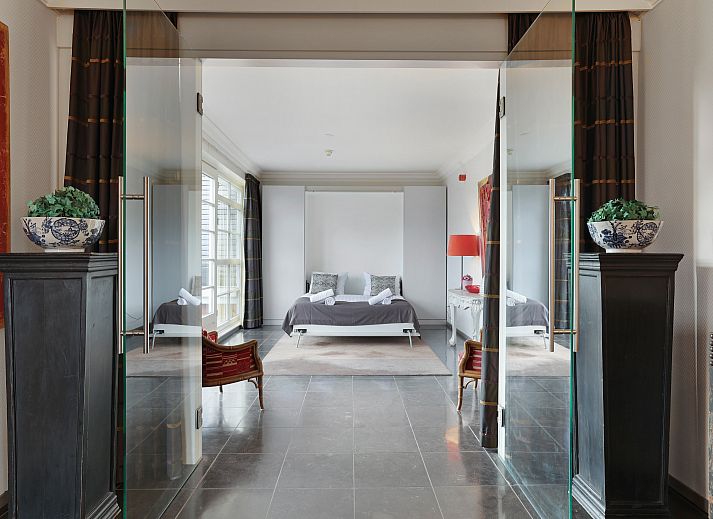 Cozy living room of Kasteeldomein De Cauberg penthouse in Valkenburg a.d. Geul, South Limburg. Luxury vacation accommodation with comfortable seating area.