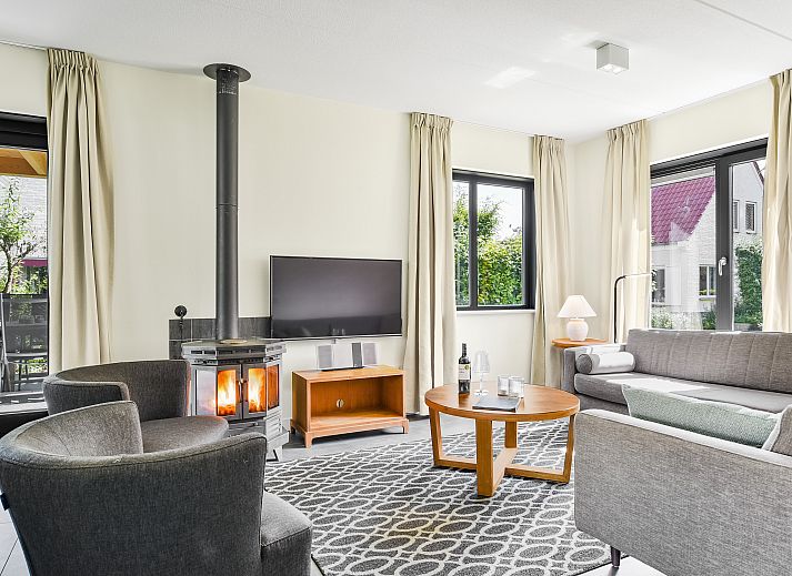 Cozy living room with wood stove in Kasteeldomein De Cauberg 10-person Villa Culinair, Valkenburg a.d. Geul.