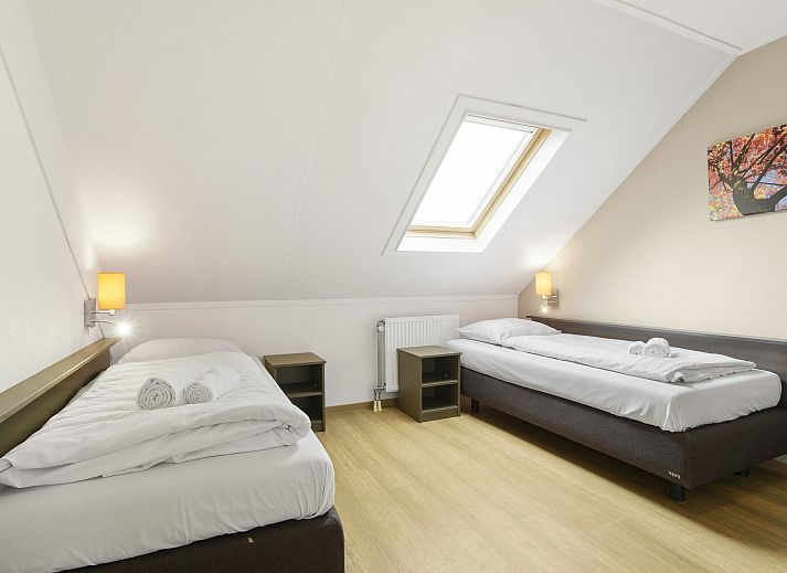 Stylish sitting area in Hoog Vaals 8-person bungalow 8L2, Limburg, with fireplace and wine.