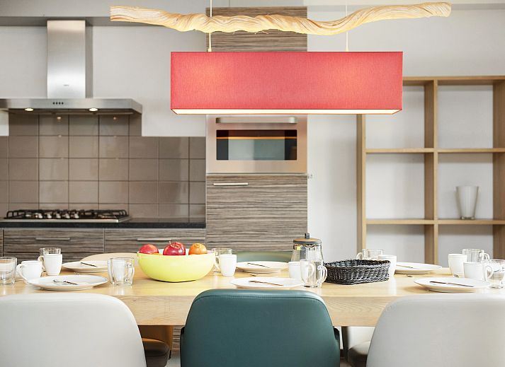 Dining area in Hoog Vaals bungalow 8L2, Vaals, with modern kitchen and large dining table.