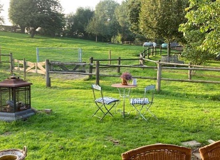 Cozy veranda at Holiday home in Nuth, South Limburg, with sitting area and green surroundings.