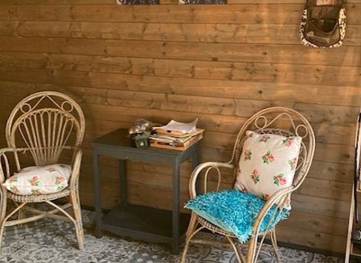 Cozy veranda at Holiday home in Nuth, South Limburg, with sitting area and green surroundings.
