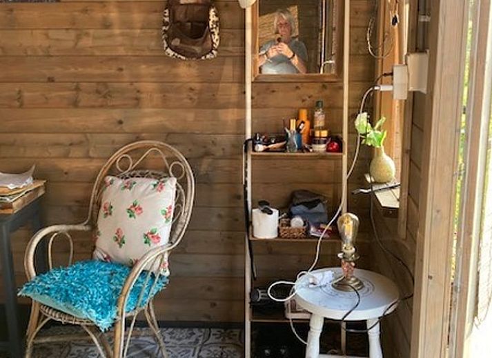 View of green meadows from Holiday home in Nuth, South Limburg, with charming sitting area.