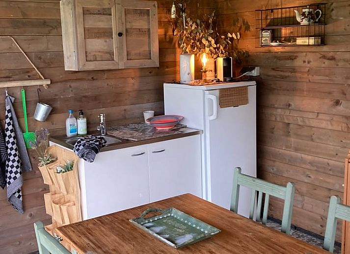 View of green meadows from Holiday home in Nuth, South Limburg, with charming sitting area.