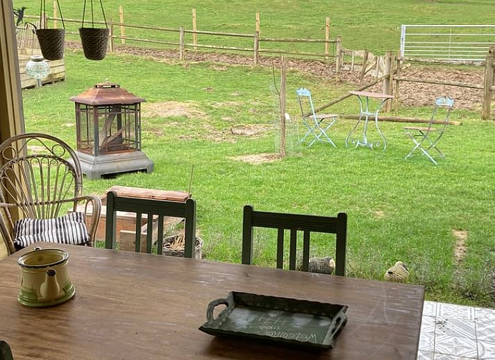Cozy interior of Holiday Home in Nuth, South Limburg, with comfortable rattan chairs.