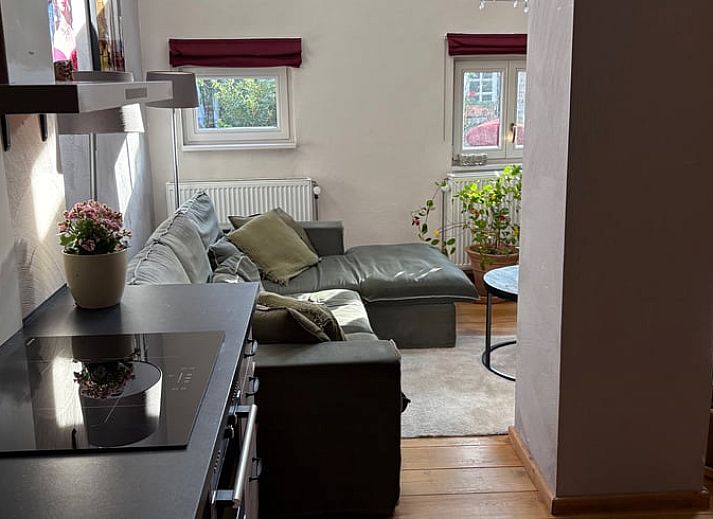 Cozy terrace at Holiday Home in Beutenaken, South Limburg, with rustic stone walls and wrought iron garden furniture for relaxing moments outdoors.