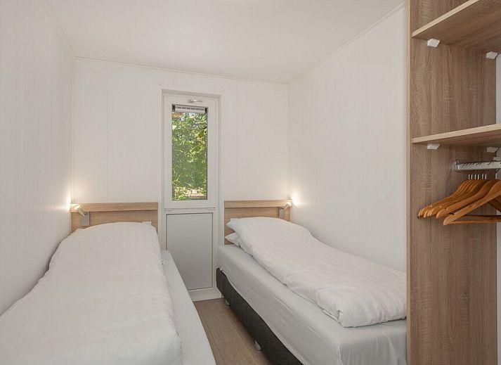 Gemuetliches Wohnzimmer von Lodge 6 in Mierlo, De Peel, mit Blick auf die Natur durch grosse Fenster, ideales Ferienhaus in Nordbrabant.