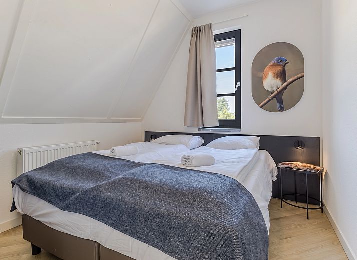 Gezellige woonkamer in 10-persoonsbungalow 10EL, Someren, met uitzicht op de natuur.