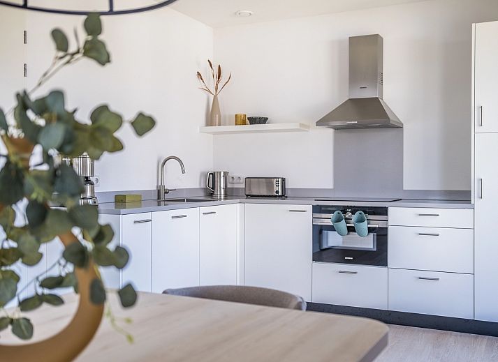 Modern living room of 6-bed bungalow 6CK in Someren, De Peel, North Brabant with open kitchen.