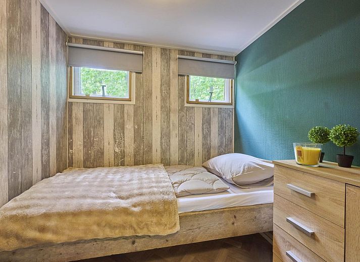Gezellige slaapkamer in 't Heische hofje, vakantiehuis in Zeeland, De Peel, Noord Brabant, met comfortabel bed en uitzicht op de natuur.