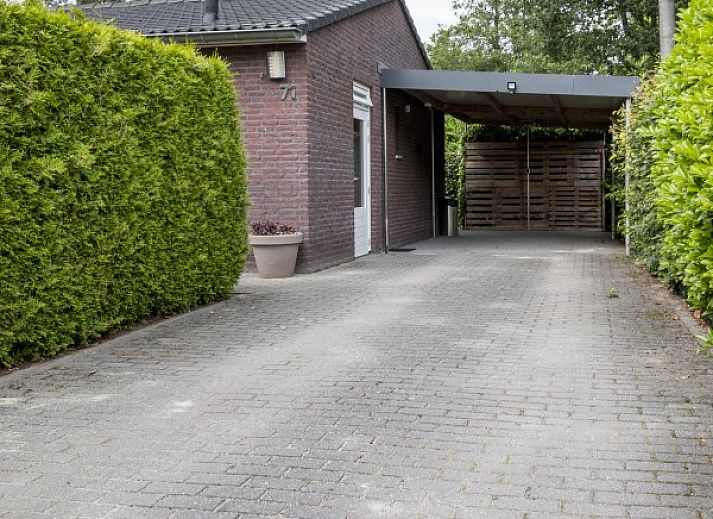 Spacious terrace at bungalow Quiet in nature, Lage Mierde, surrounded by greenery, ideal for outdoor dining in nature.