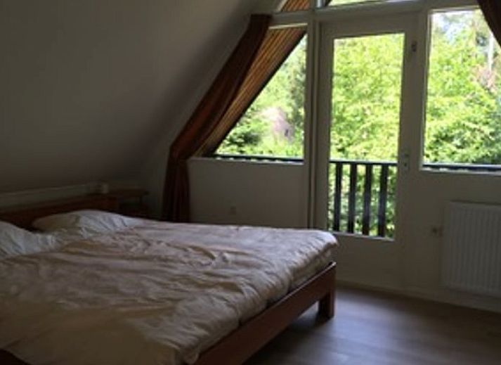 Interior of Holiday Home in Eersel, Kempen, North Brabant with art on the wall and an open door to the hallway.