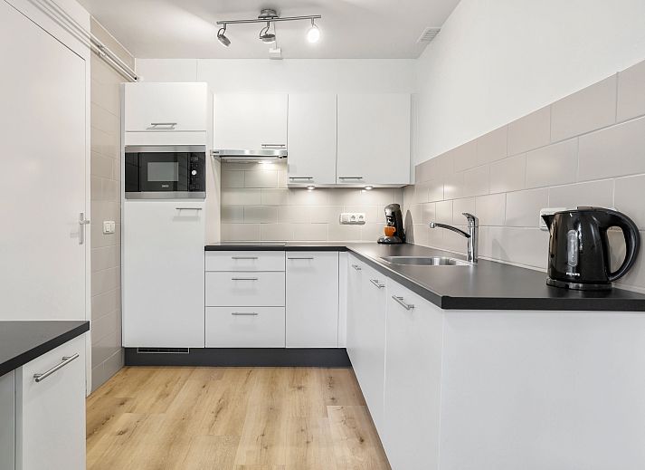 Comfortable sitting area in Het Vennenbos bungalow, ideal for relaxation in Hapert.