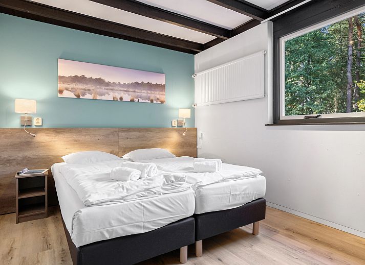 Spacious living room with dining area in Het Vennenbos bungalow, Hapert.