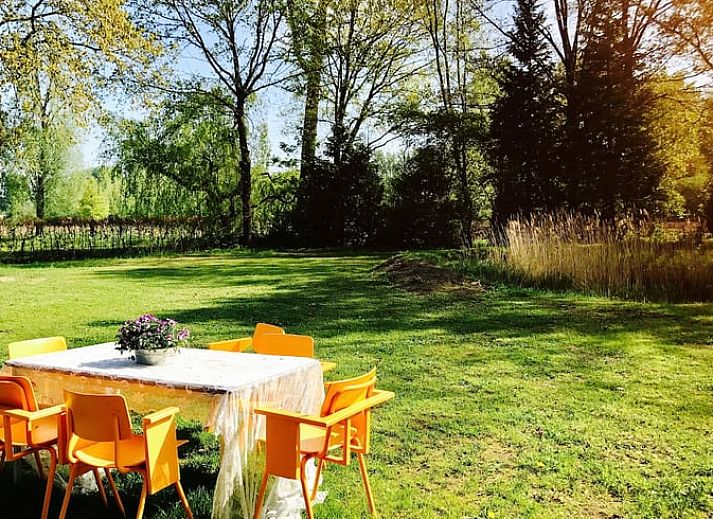 Cozy dining area in Holiday home in Liempde, Heart of Brabant overlooking the green garden.