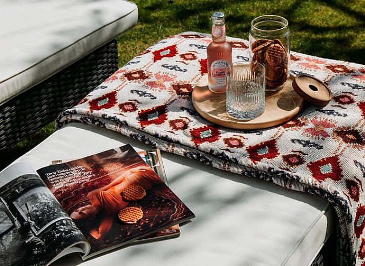 Sunny garden of Holiday Home in Chaam, North Brabant with modern wooden finishes and natural surroundings.