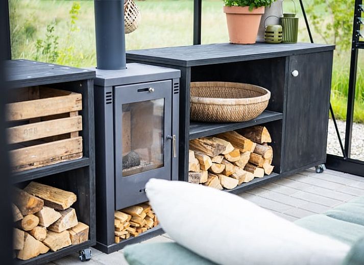 Sunny garden of Holiday Home in Chaam, North Brabant with modern wooden finishes and natural surroundings.