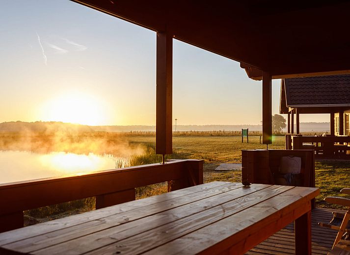 Water lodge in Chaam, Heart of Brabant, overlooking the serene lake and green surroundings.