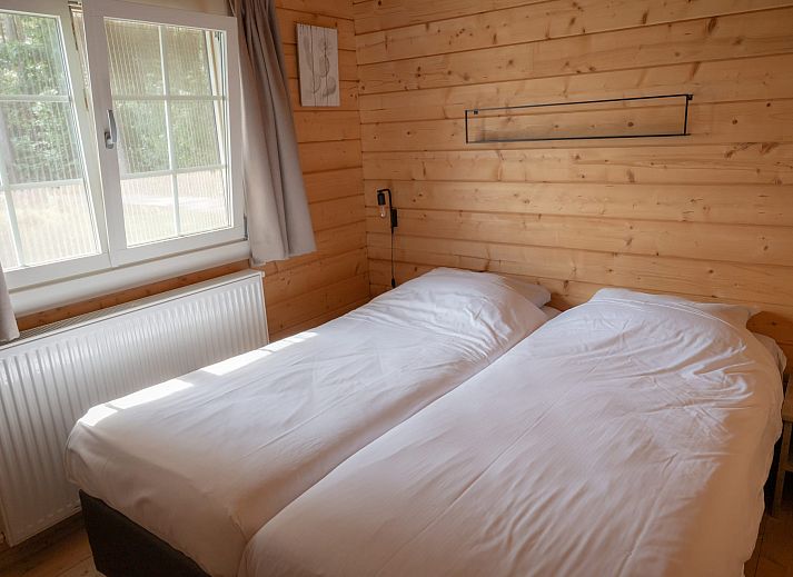 Water lodge in Chaam, Heart of Brabant, overlooking the serene lake and green surroundings.