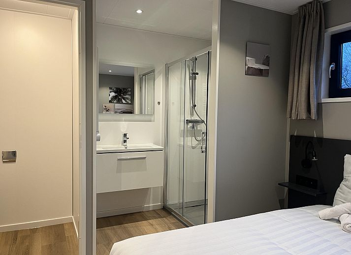 Stylish living room of the Detached house in Kaatsheuvel, Heart of Brabant, overlooking the green garden through large windows.