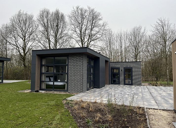Stylish living room of the Detached house in Kaatsheuvel, Heart of Brabant, overlooking the green garden through large windows.