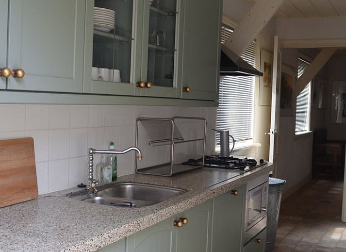 Geniet van de serene tuin met zithoek bij Vakantiehuisje in Sleeuwijk, Hart van Brabant, Noord Brabant.