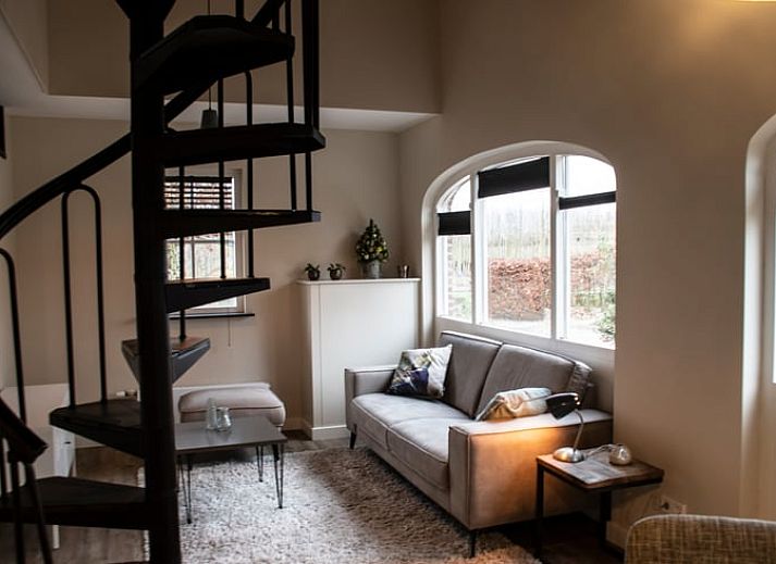 Cozy living room with spiral staircase in Holiday home in Boxtel, Heart of Brabant, North Brabant.