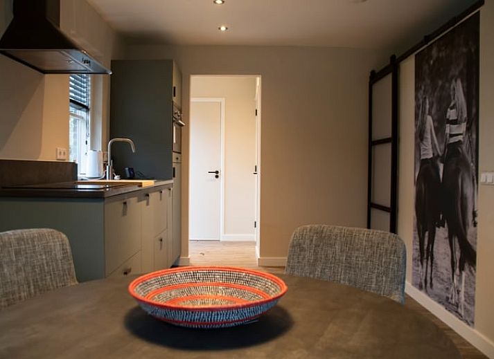 Cozy living room with spiral staircase in Holiday home in Boxtel, Heart of Brabant, North Brabant.