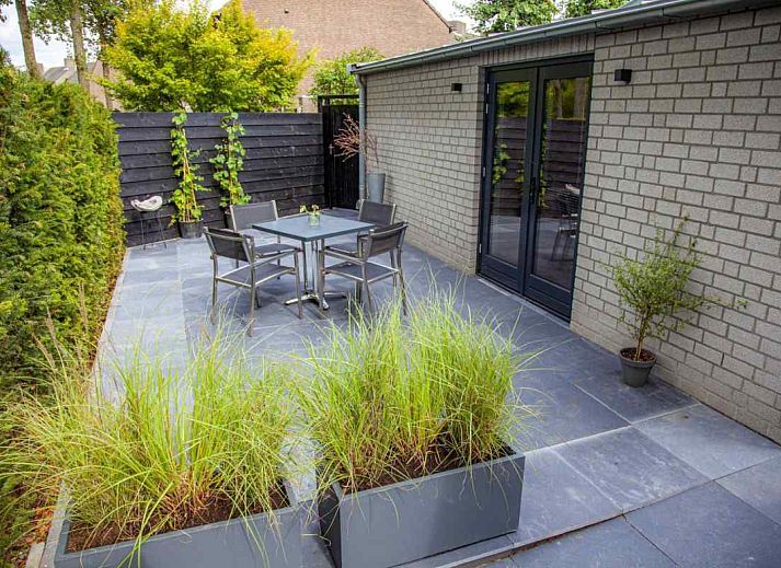 Attractive bedroom in BRA045 vacation home Geffen with brick wall and artwork.