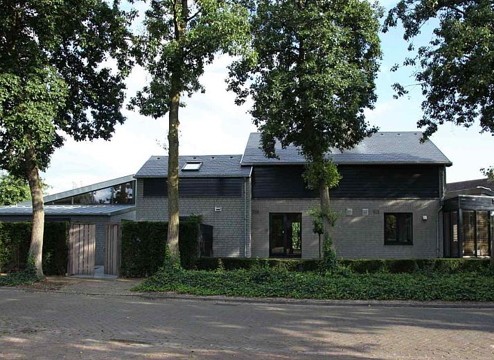 Attractive bedroom in BRA045 vacation home Geffen with brick wall and artwork.