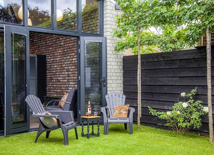 Attractive bedroom in BRA045 vacation home Geffen with brick wall and artwork.