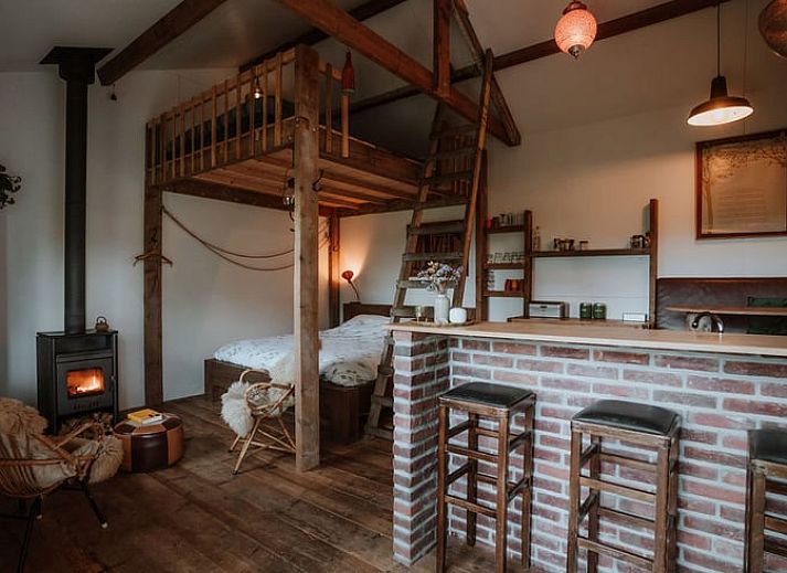 Gezellige zithoek met houtkachel in Huisje in Sint-Oedenrode, vakantiehuis in Noordoost Brabant.