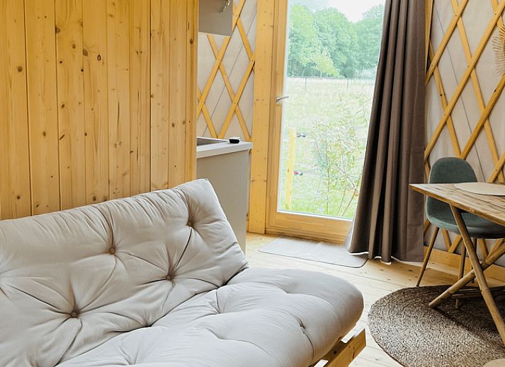 Bright interior of Holiday Home in Ledeacker with comfortable seating and wooden interior.