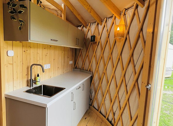 Bright interior of Holiday Home in Ledeacker with comfortable seating and wooden interior.