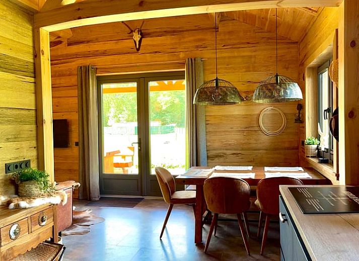 Cozy kitchen and dining area in Holiday Home in Ledeacker, Northeast Brabant with wooden interior and modern amenities.