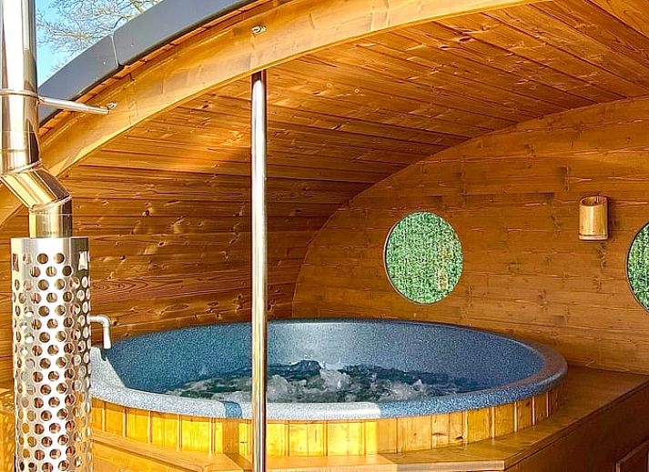 Cozy interior of Holiday Home in Ledeacker, northeast Brabant, with wooden interior and comfortable sitting area.