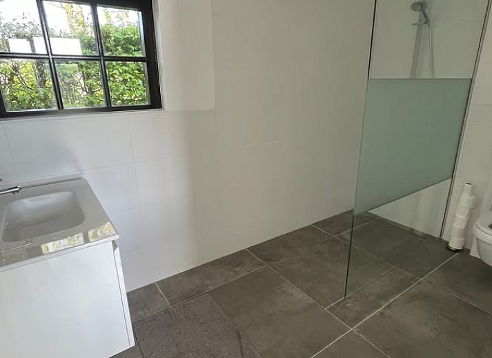 Lichte binnenruimte van Vakantiehuisje in Breda met uitzicht op tuin.