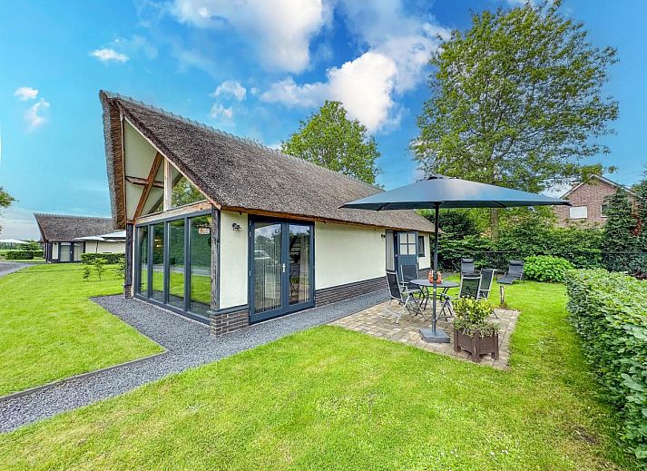 Open living space with kitchen and sitting area in Villa Brocante, vacation home in Alphen, West Brabant.