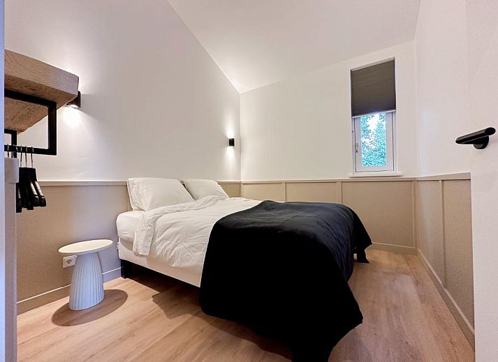 Dining area in De Stal vacation home in Rijsbergen, North Brabant with large dining table and atmospheric lighting.